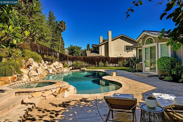 view of swimming pool featuring an in ground hot tub and a patio