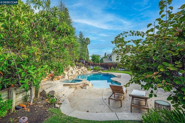 view of swimming pool featuring an in ground hot tub and a patio area