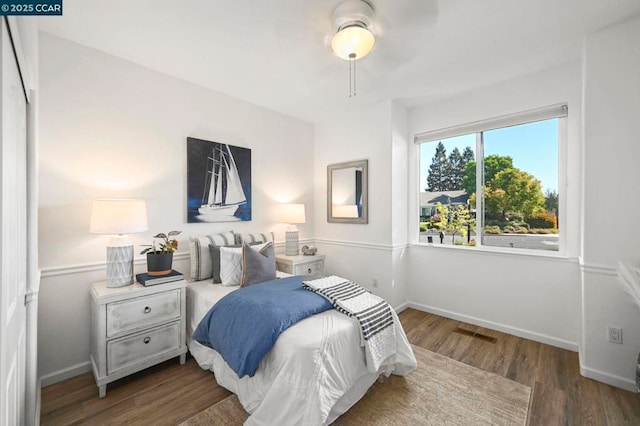 bedroom with dark wood-type flooring