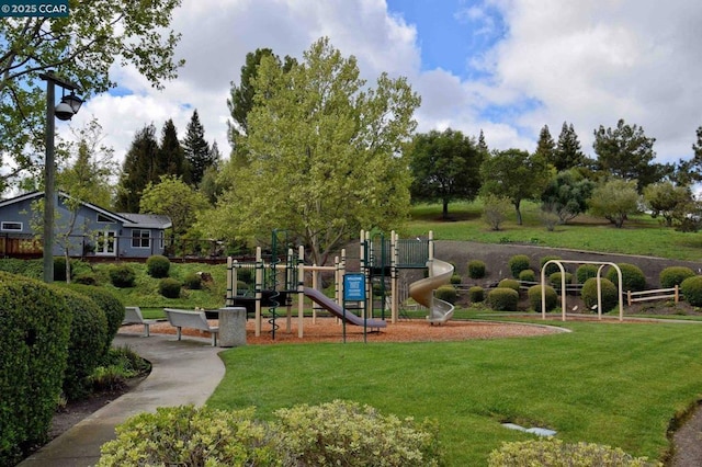 view of community with a playground and a lawn