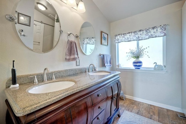 bathroom featuring vanity and hardwood / wood-style flooring