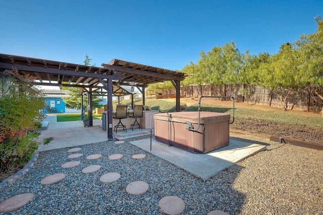 view of yard with a pergola, a hot tub, a patio, and exterior bar