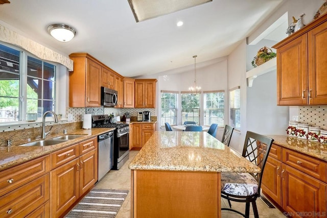 kitchen with pendant lighting, a breakfast bar area, a center island, and appliances with stainless steel finishes