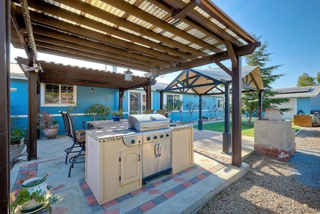 view of patio / terrace with exterior bar, area for grilling, and a pergola