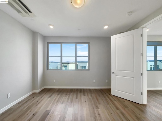 spare room with light hardwood / wood-style flooring