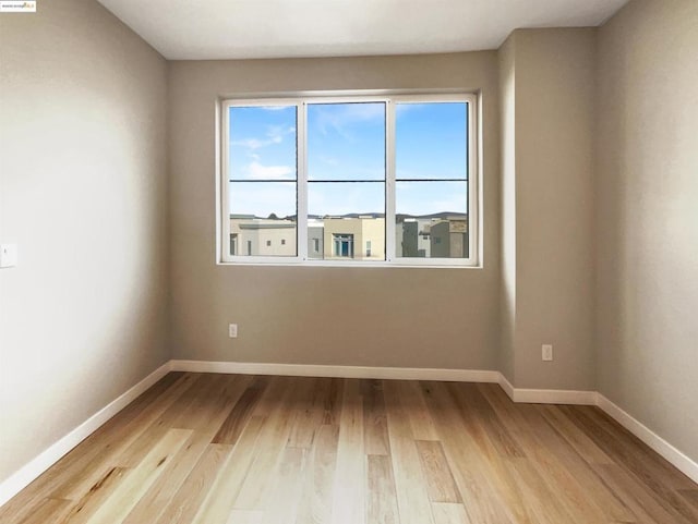 unfurnished room with light hardwood / wood-style flooring