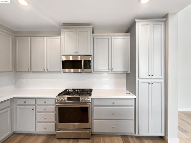 kitchen featuring light hardwood / wood-style floors, gray cabinets, and stainless steel appliances