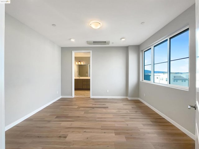 spare room with light wood-type flooring