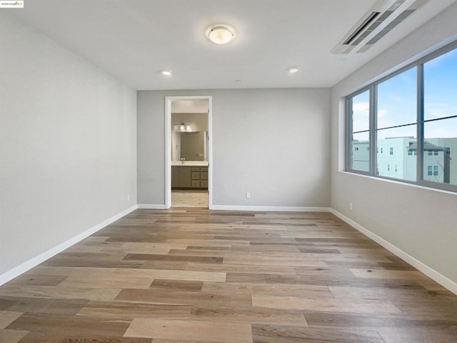 empty room with light hardwood / wood-style flooring