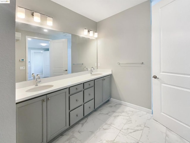 bathroom featuring an AC wall unit and vanity