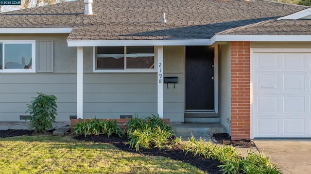 view of exterior entry featuring a garage