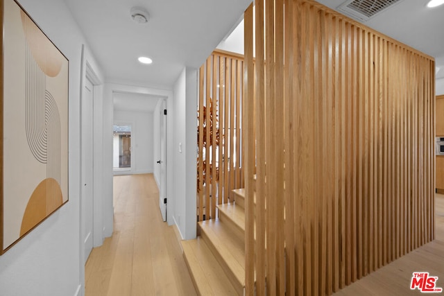 hallway with light hardwood / wood-style flooring