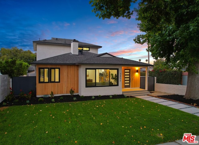 prairie-style home with a lawn