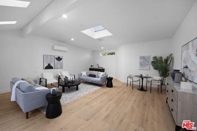 living room with vaulted ceiling with skylight, light hardwood / wood-style floors, and an AC wall unit