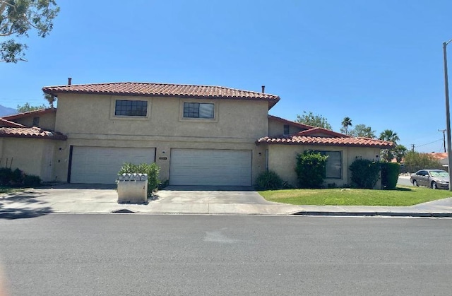 mediterranean / spanish-style house with a garage