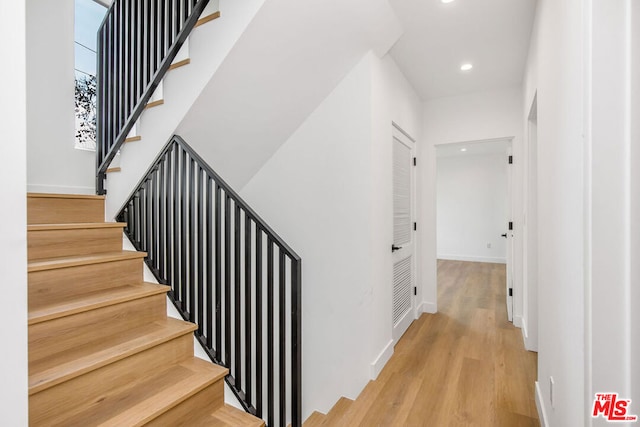 stairs featuring hardwood / wood-style flooring