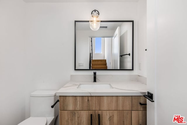 bathroom featuring toilet and vanity