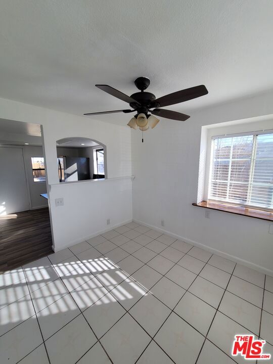 interior space featuring ceiling fan and light tile patterned floors