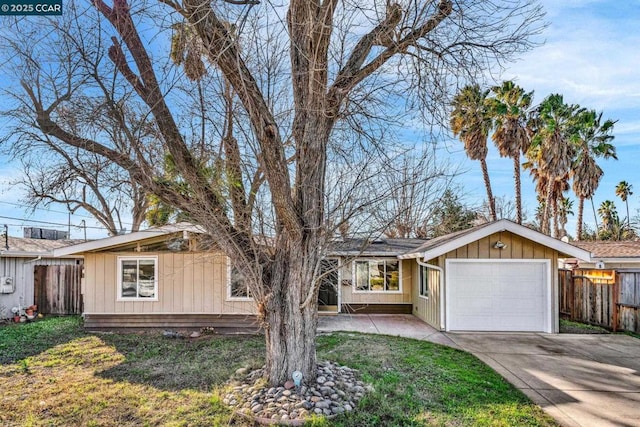 ranch-style house with a garage and a front lawn