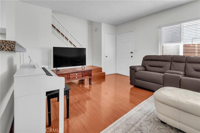 living room featuring a textured ceiling and hardwood / wood-style flooring