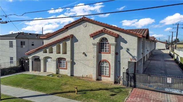 mediterranean / spanish house with a front lawn