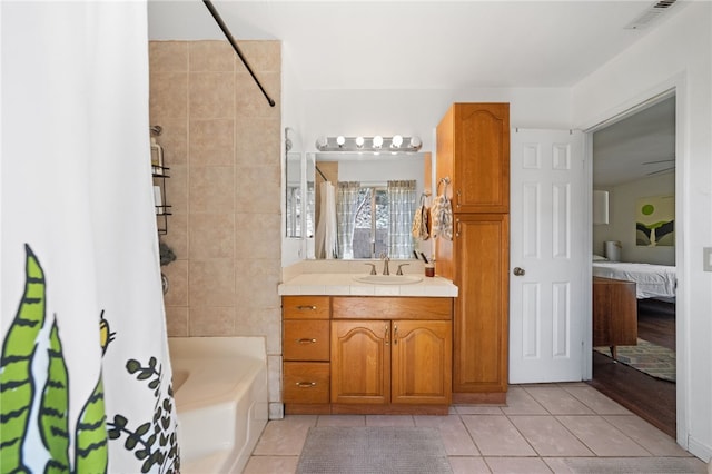 bathroom featuring tile patterned floors, vanity, and shower / bath combo