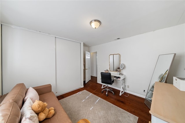 office space with dark wood-type flooring