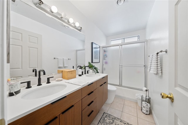 full bathroom with toilet, tile patterned flooring, enclosed tub / shower combo, and vanity