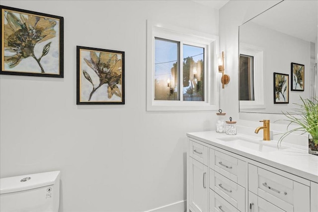 bathroom featuring vanity and toilet