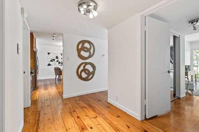 corridor with light wood-type flooring