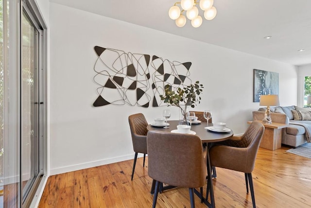 dining room featuring hardwood / wood-style floors and an inviting chandelier