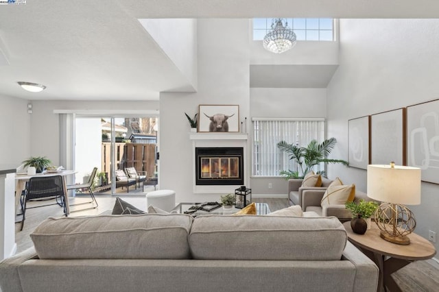 living room featuring hardwood / wood-style floors, plenty of natural light, and a notable chandelier