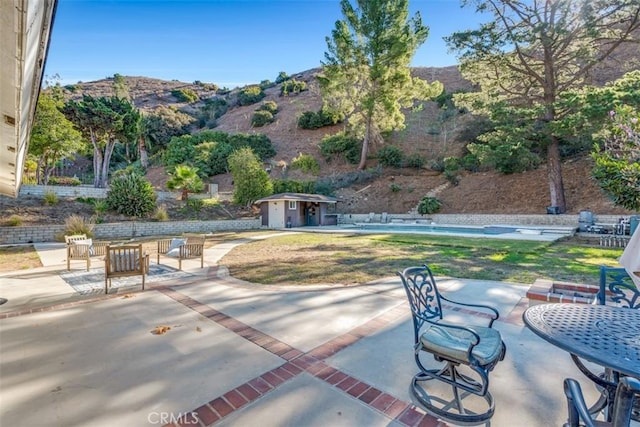 view of patio / terrace featuring a mountain view and an outdoor structure