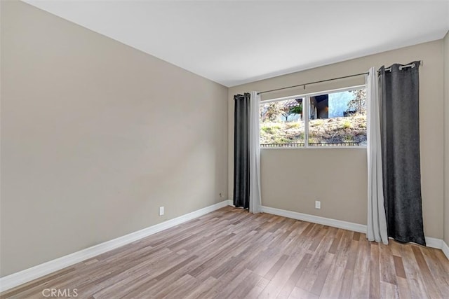 unfurnished room with light wood-type flooring