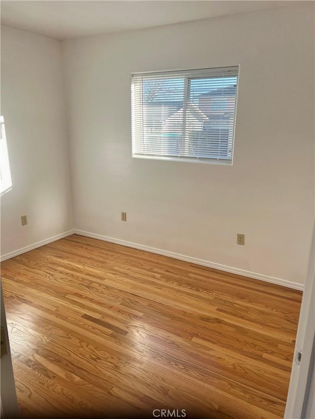 spare room with light wood-type flooring