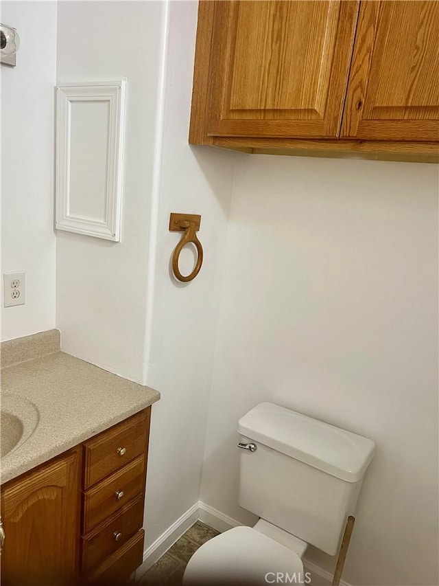 bathroom featuring toilet and vanity