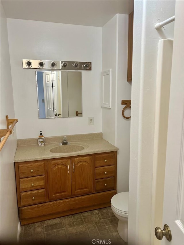 bathroom featuring toilet and vanity