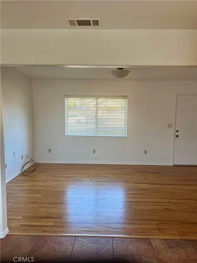 unfurnished room with hardwood / wood-style floors