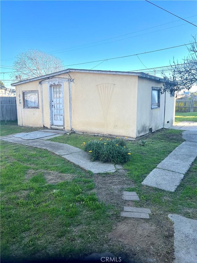 view of property exterior featuring a lawn