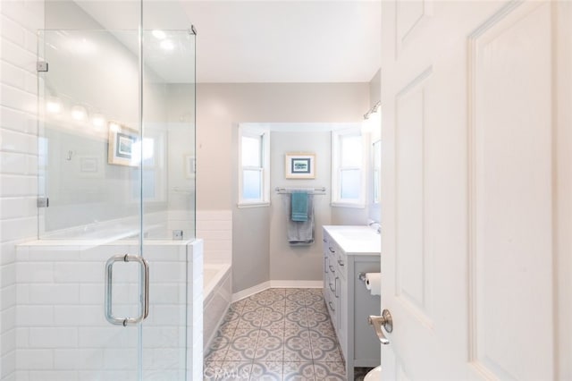 bathroom with tile patterned floors, vanity, and a shower with door