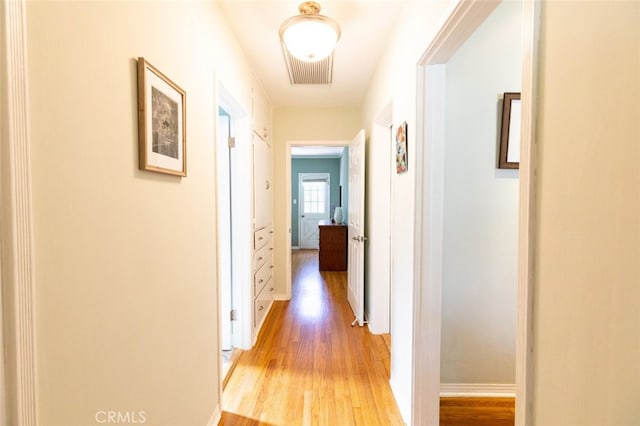 corridor featuring light hardwood / wood-style floors