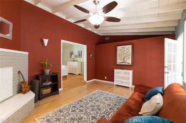 living room featuring lofted ceiling with beams, wooden ceiling, and light wood-type flooring