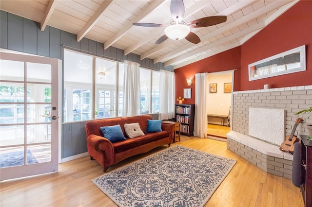 sitting room featuring ceiling fan, light hardwood / wood-style floors, lofted ceiling with beams, and wooden ceiling