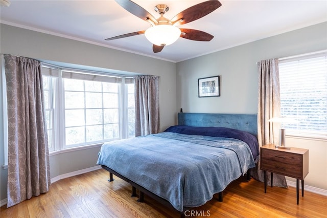 bedroom featuring ornamental molding, hardwood / wood-style floors, and ceiling fan