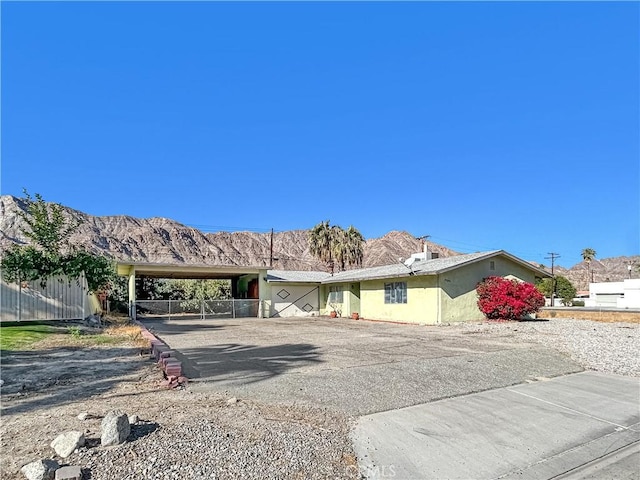 ranch-style house with a mountain view and a carport