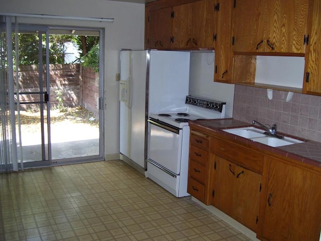 kitchen with sink, white range with electric stovetop, and decorative backsplash