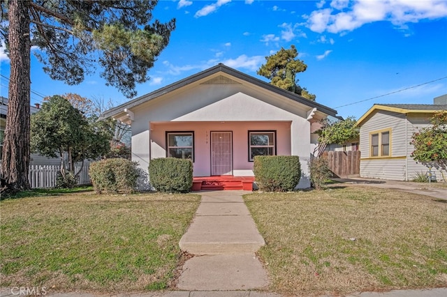 bungalow-style house featuring a porch and a front yard