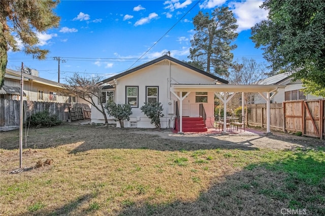 rear view of property with a lawn