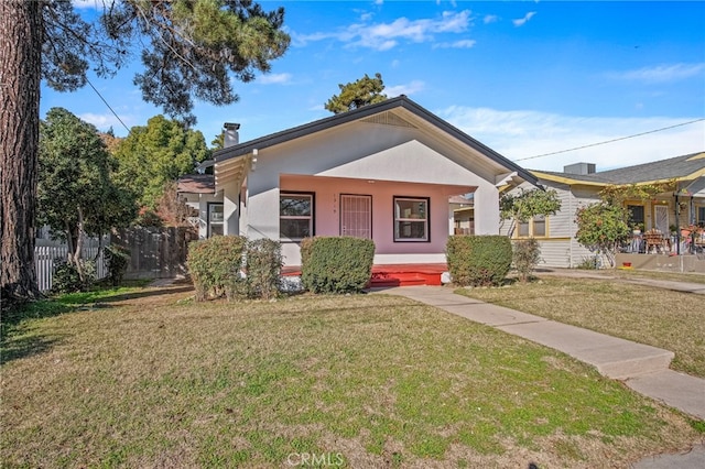 view of front of home featuring a front lawn and covered porch