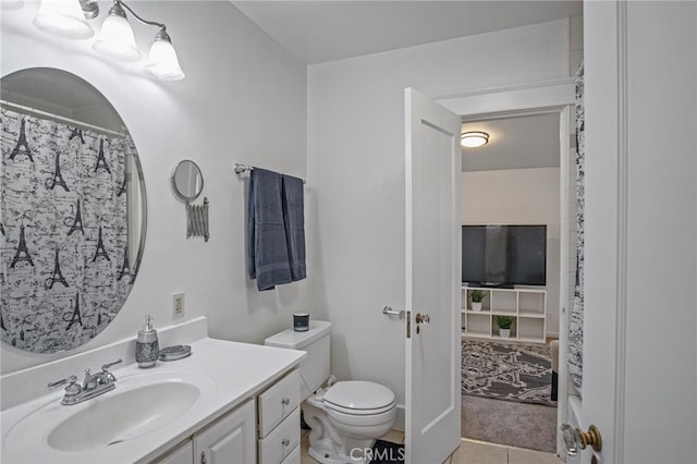 bathroom featuring toilet, tile patterned flooring, and vanity